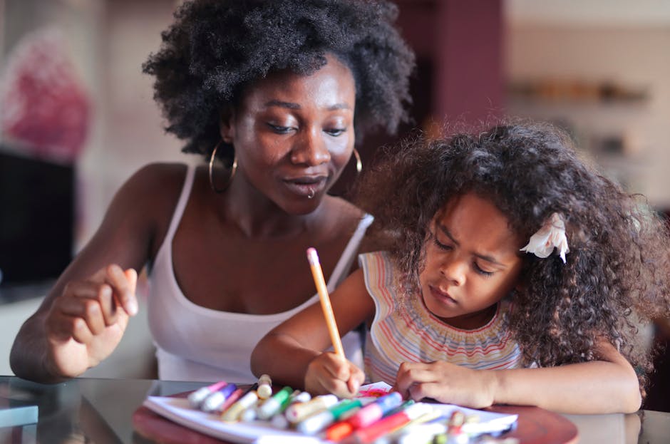 A loving mother and daughter bonding over a coloring activity at home.