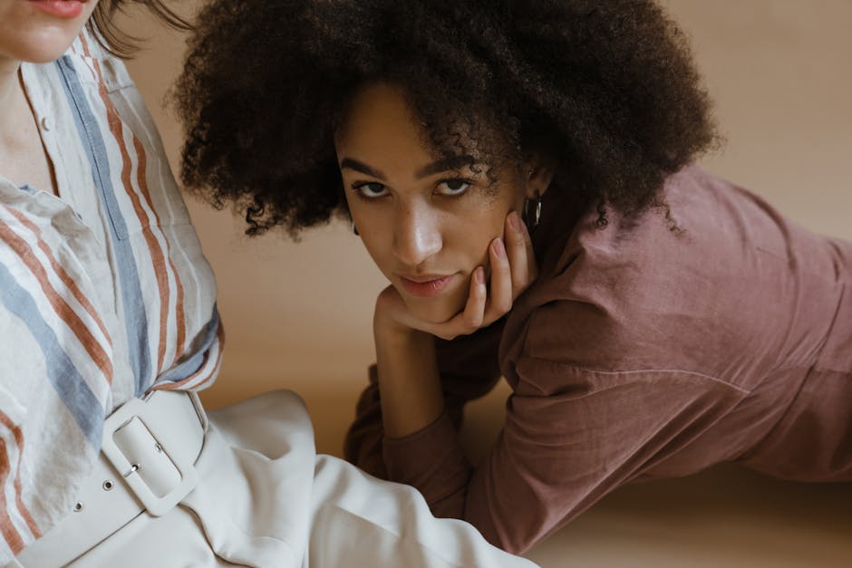 Relaxed and stylish women in a studio with natural beauty and afro hair.