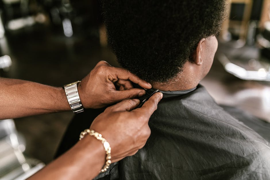 Close-up of a professional haircut in progress at a modern barbershop, focusing on precision and style.