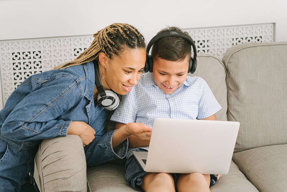 Mother and child sharing happy moments together using a laptop at home.